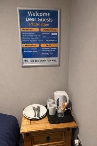 a sign on a wall above a table with coffee cups at 2nd DANESGATE in Lincoln +2 photos
