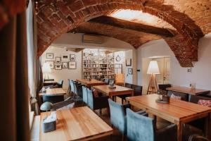 a dining room with wooden tables and chairs at Piwnica Rycerska Kęty in Kęty