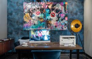 an office with a desk with a computer on it at NYX Hotel Madrid by Leonardo Hotels in Madrid +60 photos