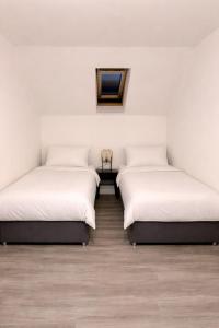 three beds in a room with white walls and wooden floors at Modern Spacious Flat In Ipswich - Sleeps 6 - Parking in Freston