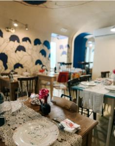 a dining room with a table with graffiti on the wall at Albergo La Prora in Capri