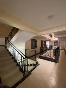 an empty hallway with stairs in a building at Aurora Loisse Suites in Nakuru