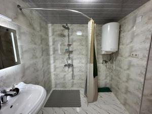 a bathroom with a shower and a sink at Matua guest house in Jvari +47 photos