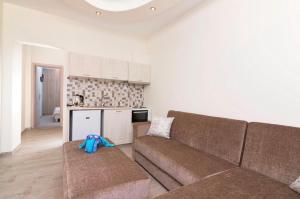 a living room with a couch and a blue stuffed animal at Lena Apartments Potos Thassos in Potos