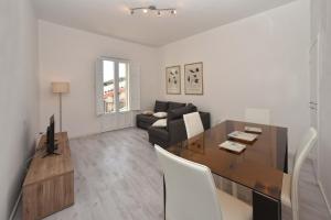 a living room with a table and a couch at Sud Casa Vacanze in Ragusa +11 photos