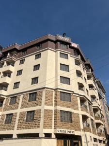 a tall apartment building with a blue sky in the background at T-Homes in Thika