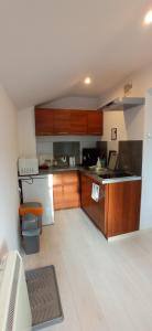a kitchen with wooden cabinets and a counter top at na Słowackiego9m7 in Szklarska Poręba