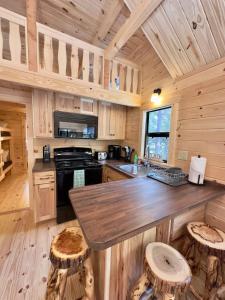 a kitchen with a large island in a wooden cabin at Cozy Coastal Cabin 2 in Steuben