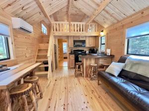a living room and kitchen of a tiny house at Cozy Coastal Cabin 2 in Steuben