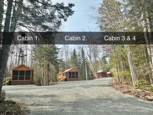 a sign that says cabin and a house in the woods at Cozy Coastal Cabin 2 in Steuben +19 photos