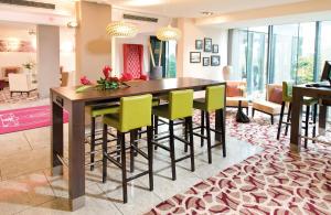 a dining room with a table and chairs at Leonardo Hotel Hannover Airport in Hannover