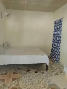 a bedroom with a bed and a rug at Happy Corner Beach Garden in How Ba