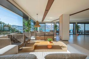 a living room with couches and a table at Leonardo Royal Hotel Mallorca in Palmanova +59 photos