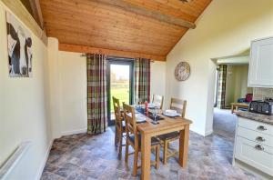 a kitchen and dining room with a wooden table and chairs at 2 Bed in Llandinam oc-waa377 in Llandinam