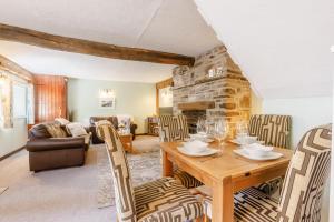 a living room with a wooden table and chairs at 2 Bed in Swimbridge oc-n0208 in Swimbridge