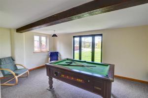 a room with a pool table and a chair at 1 Bed in Llandinam oc-waa376 in Llandinam