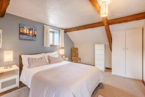 a bedroom with a white bed and a window at 2 Bed in Swimbridge oc-n0208 in Swimbridge