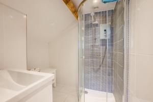 a white bathroom with a shower and a sink at 2 Bed in Swimbridge oc-n0208 in Swimbridge +19 photos