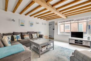 a living room with a couch and a tv at 2 Bed in Southwold oc-19cs in Southwold