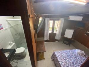a small bathroom with a toilet and a shower at Pousada Cantuá in Ilha do Mel +58 photos