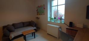a living room with a couch and a table and a window at na Słowackiego9m7 in Szklarska Poręba +6 photos