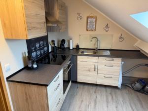 a small kitchen with a sink and a stove at Eifelnest Stadtkyll in Stadtkyll