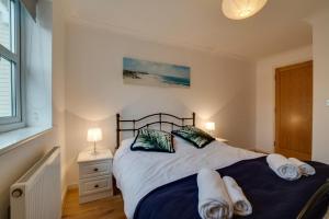 a bedroom with a bed with towels on it at 2 Bed in Broadstairs oc-th013 in Broadstairs