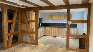 a kitchen with wooden walls and a counter top at Chez Netty Gite avec sauna à Beblenheim in Beblenheim