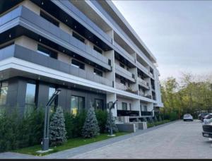 a large building with christmas trees in front of it at LVO Apartments in Bîrlad