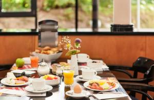a table with breakfast foods and drinks on it at Hotel Magdeburg City Center by Leonardo Hotels in Magdeburg +28 photos