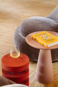 a table with a book and a glass of wine at Leonardo Hotel Groningen City Center in Groningen
