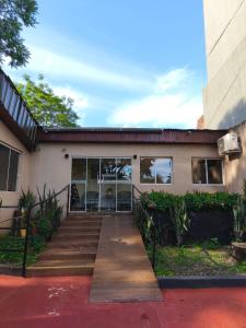 a building with a staircase in front of it at Terra Iguazú Suites in Puerto Iguazú