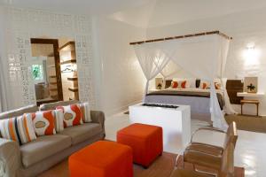 a bedroom with a canopy bed and a couch at Fazenda Shanti in Alto Paraíso de Goiás