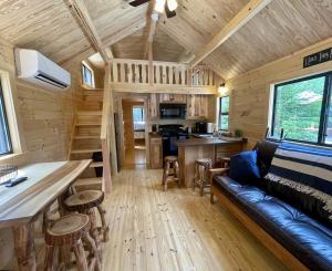 a living room and kitchen of a tiny house at Cozy Coastal Cabin 3 in Steuben +25 photos
