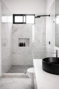 a white bathroom with a tub and a toilet at Nomad Luxe Tulum in Tulum +38 photos