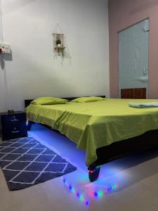 a bedroom with a bed with lights on the floor at Debox heaven Homestay in Jorhat