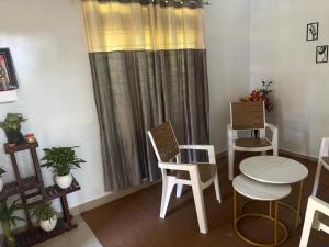 a room with a table and chairs and a window at Debox heaven Homestay in Jorhat