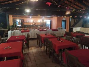 a restaurant with red and white tables and chairs at Pousada dos Guarás in Salvaterra