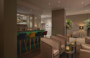 a living room with a bar and a pool table at Leonardo Hotel Heidelberg City Center in Heidelberg