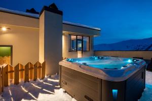 a jacuzzi tub in the snow at night at Best Western Gudauri in Gudauri