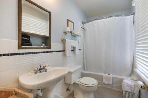 a white bathroom with a sink and a toilet at Inn On The River in Glen Rose +39 photos