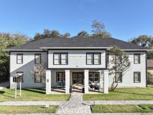 a white house with a black roof at Inn On The River in Glen Rose