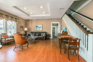 a living room filled with furniture and a staircase at Inn On The River in Glen Rose