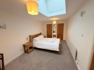 a bedroom with a bed and a skylight at Low Haven in Keswick
