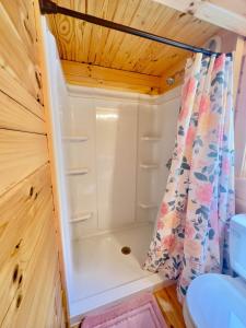 a small bathroom with a shower and a toilet at Cozy Coastal Cabin 4 in Steuben +23 photos