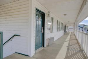 a white building with a green door and a porch at Plantation Inn & Suites Near Locust Grove I 75 in Jackson +37 photos