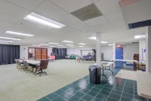 an empty room with a table and chairs at Plantation Inn & Suites Near Locust Grove I 75 in Jackson
