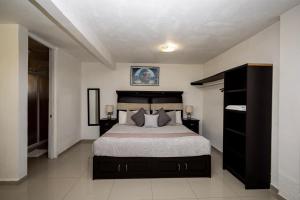 a bedroom with a large bed in a room at HOTEL LAS FUENTES in Tepotzotlán