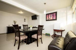 a living room with a dining room table and chairs at HOTEL LAS FUENTES in Tepotzotlán