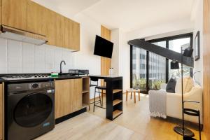 a kitchen with a dishwasher and a kitchen with a living room at Casa Colón by Wynwood House in Mexico City